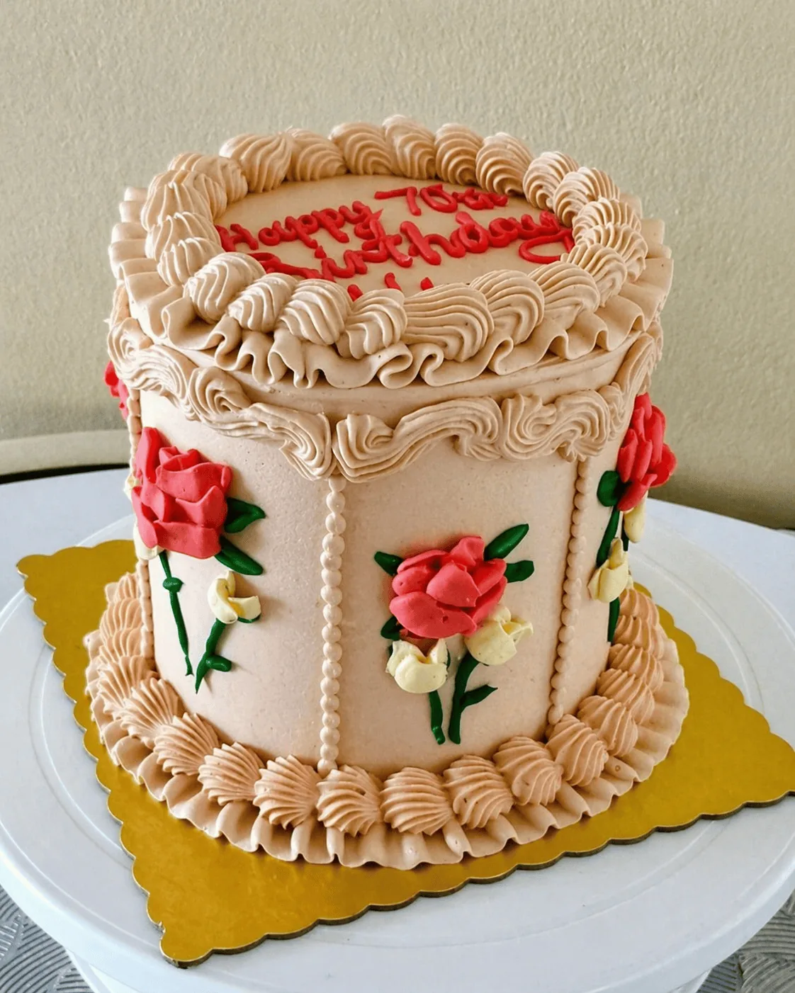 Elegant cream birthday cake with pink flowers
